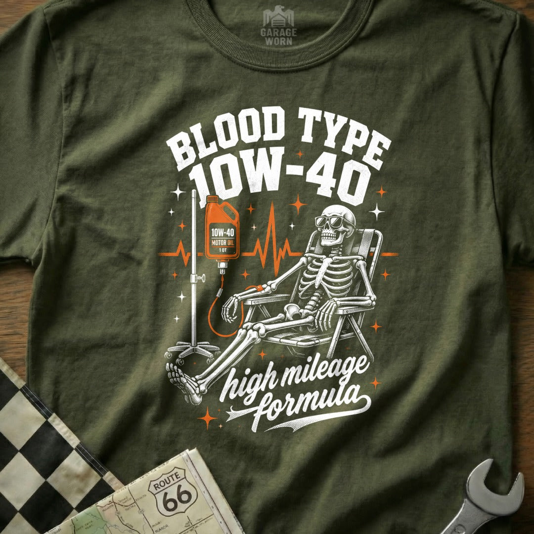 Skeleton receiving IV drip of 10W-40 motor oil, "Blood Type 10W-40 High Mileage Formula" text.