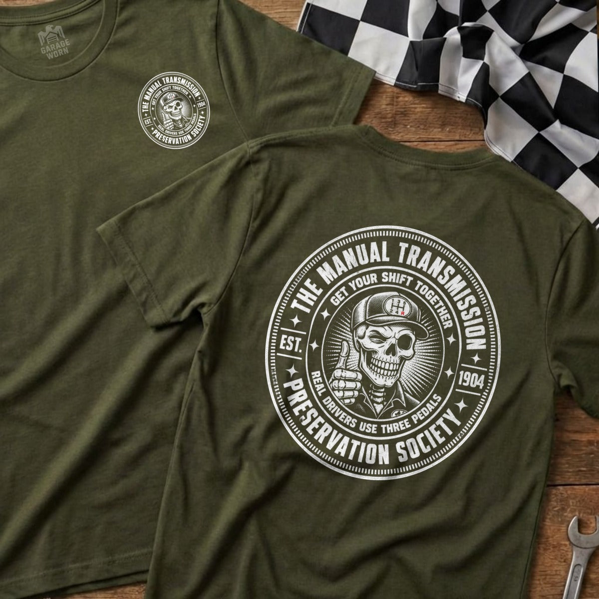 Green shirt with "Manual Transmission Preservation Society" graphic featuring a skull.
