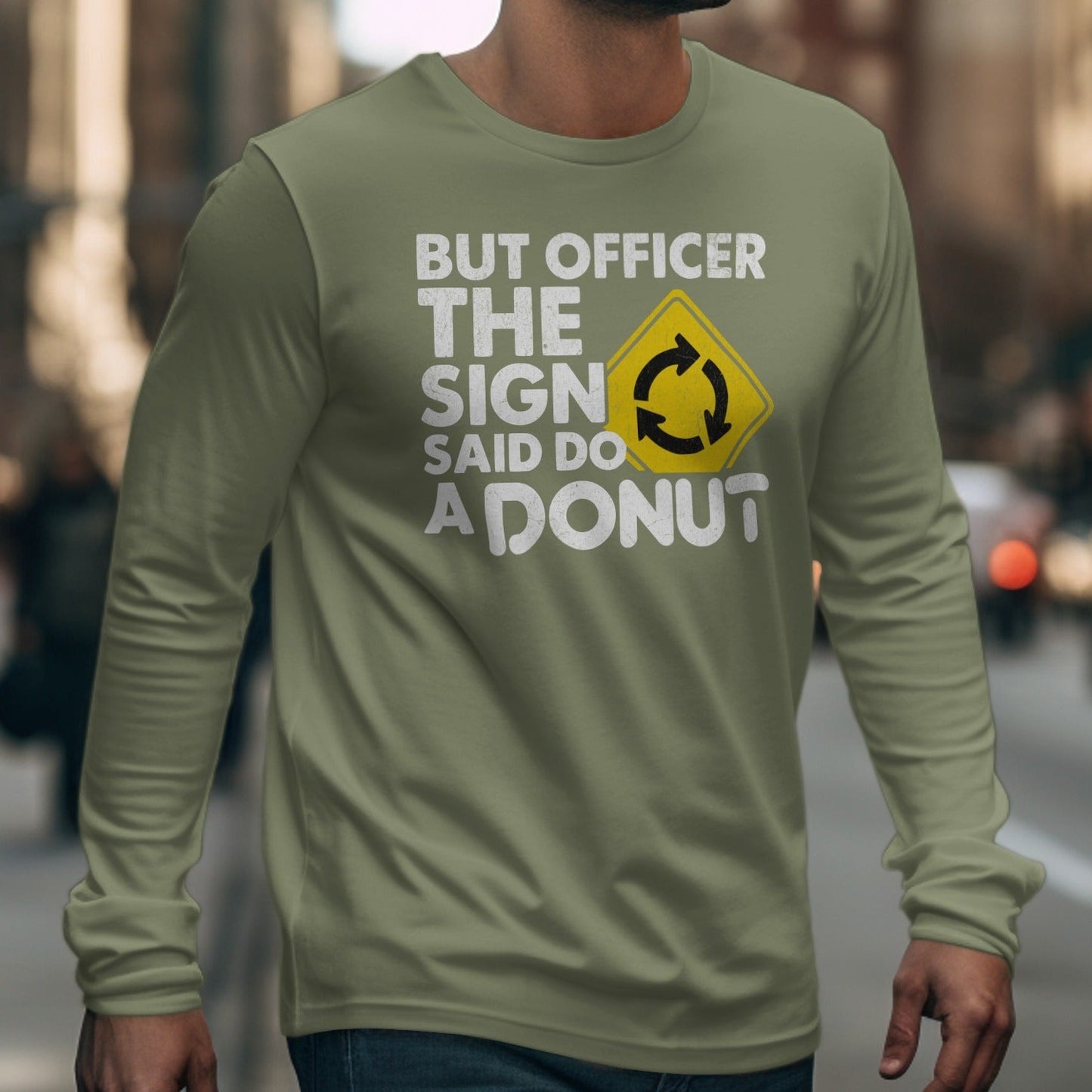 Long sleeve shirt with "BUT OFFICER THE SIGN SAID DO A DONUT" text and roundabout symbol.