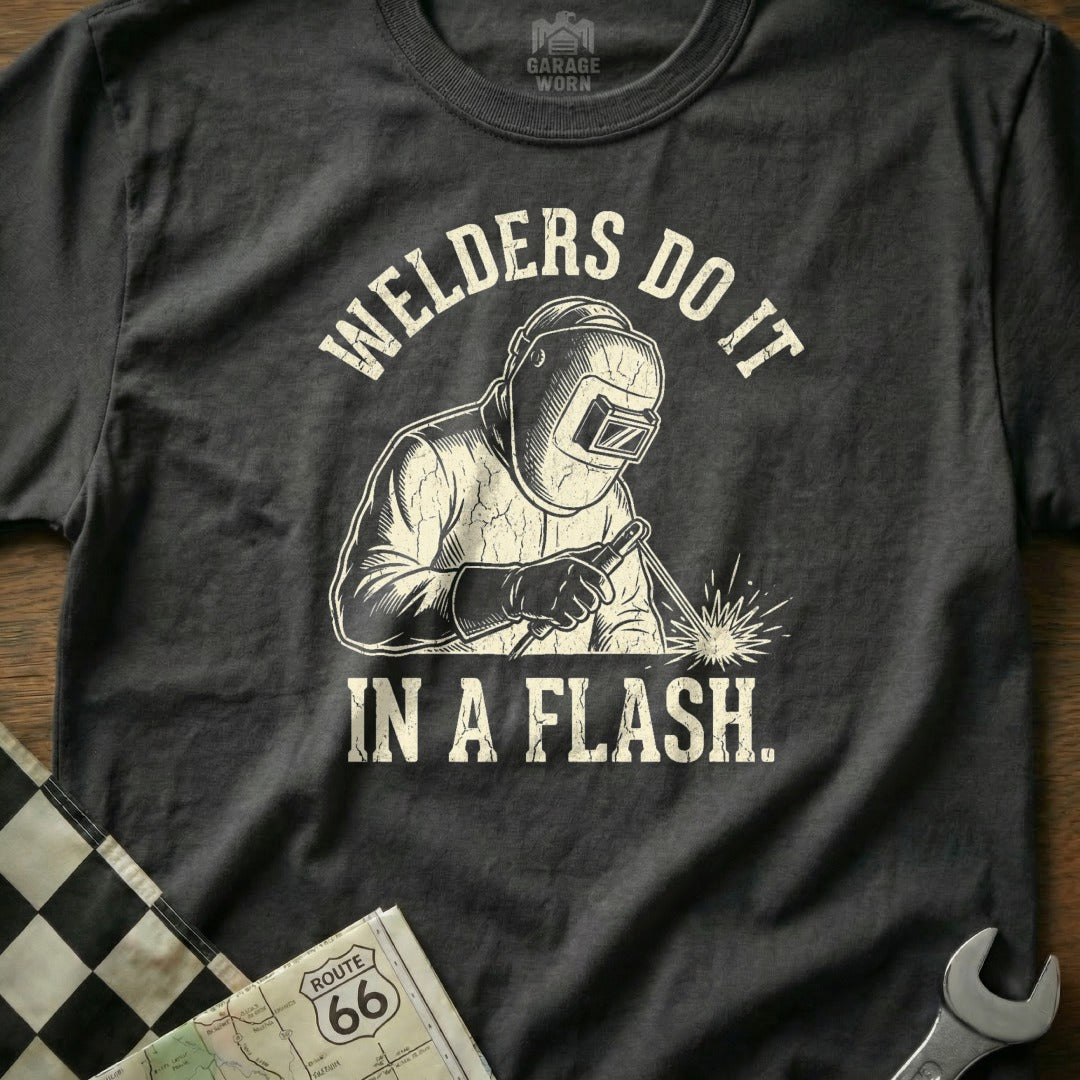 T-shirt with graphic of a welder and the text "Welders Do It In A Flash."