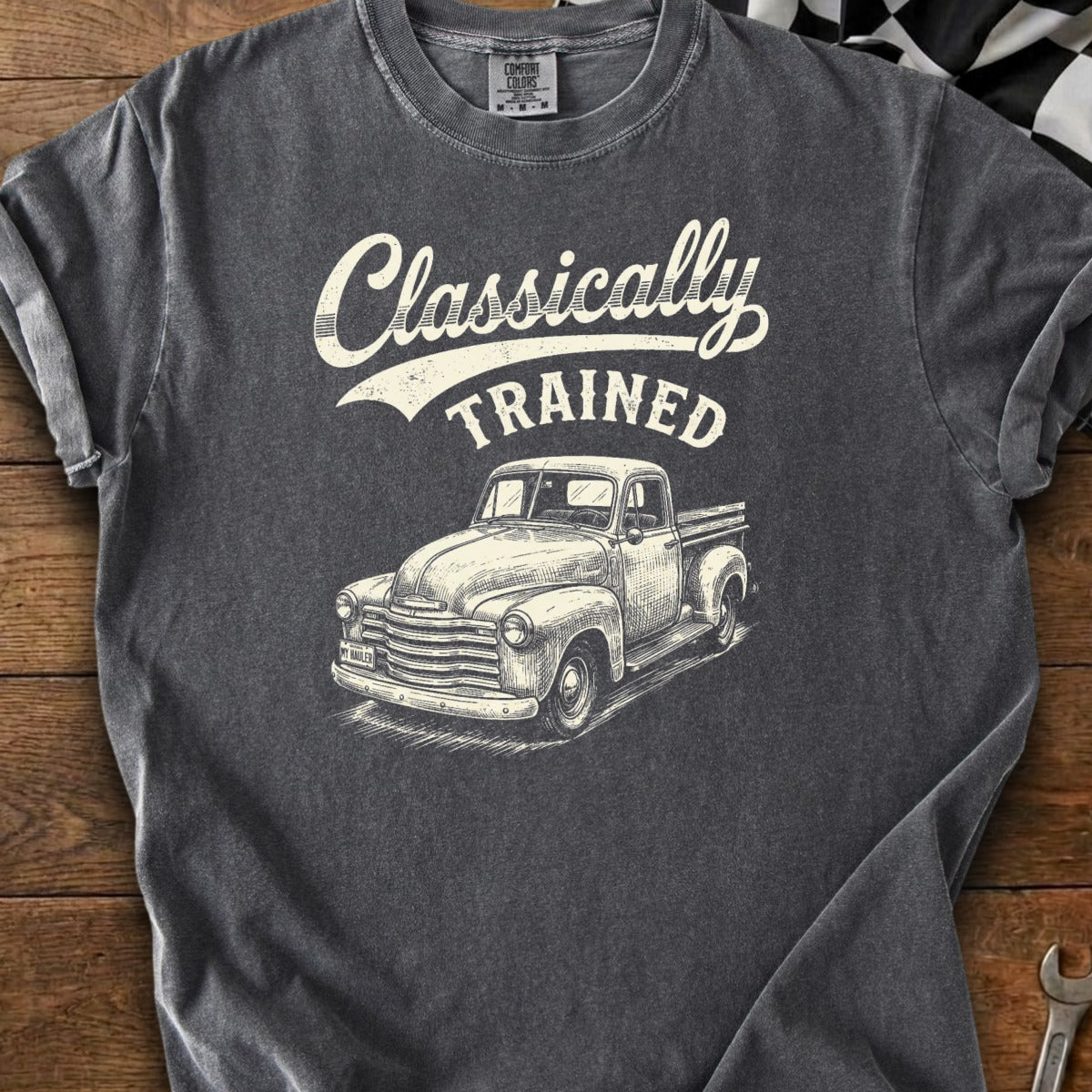 Dark grey t-shirt with a sketch of a classic pickup truck and text that reads "Classically TRAINED".