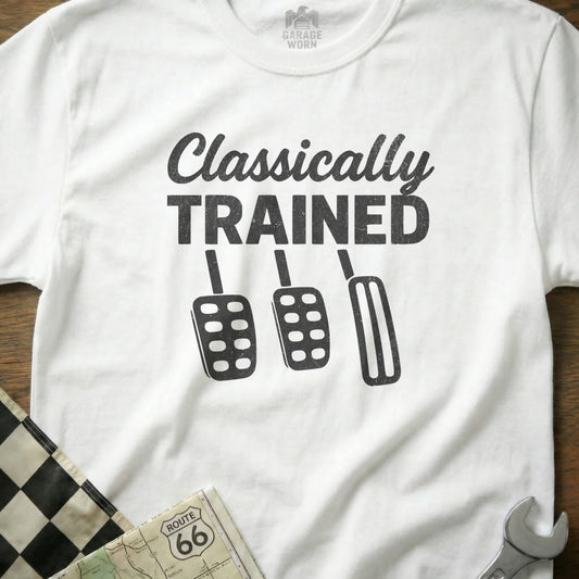 White t-shirt with "Classically Trained" text and three car pedals.
