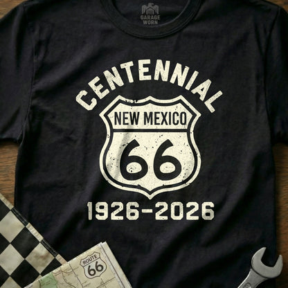 Black t-shirt with white "Centennial New Mexico 66 1926-2026" text in a Route 66 shield.