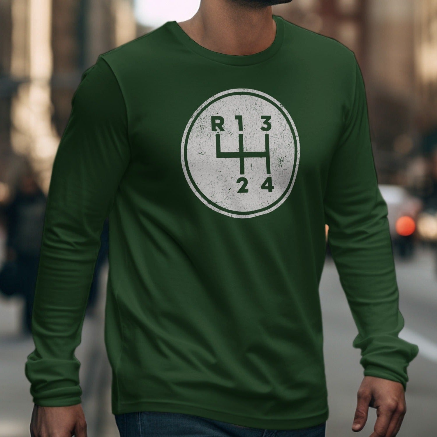 Green long-sleeve shirt with a circular graphic of a manual transmission shift pattern.