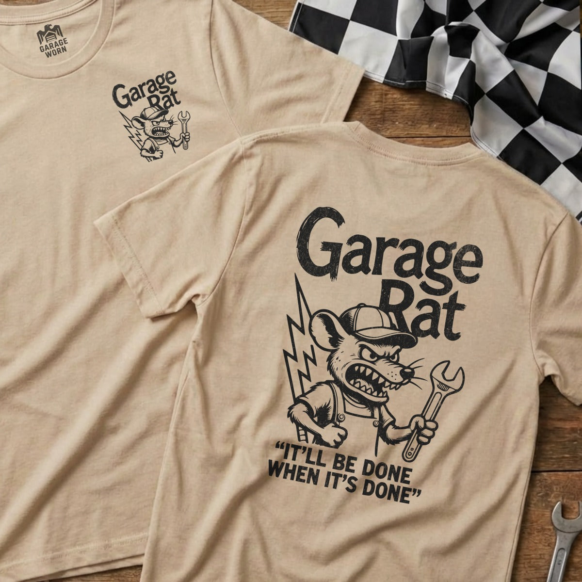 Tan t-shirt with "Garage Rat" cartoon mouse holding wrench, text "It'll be done when it's done."