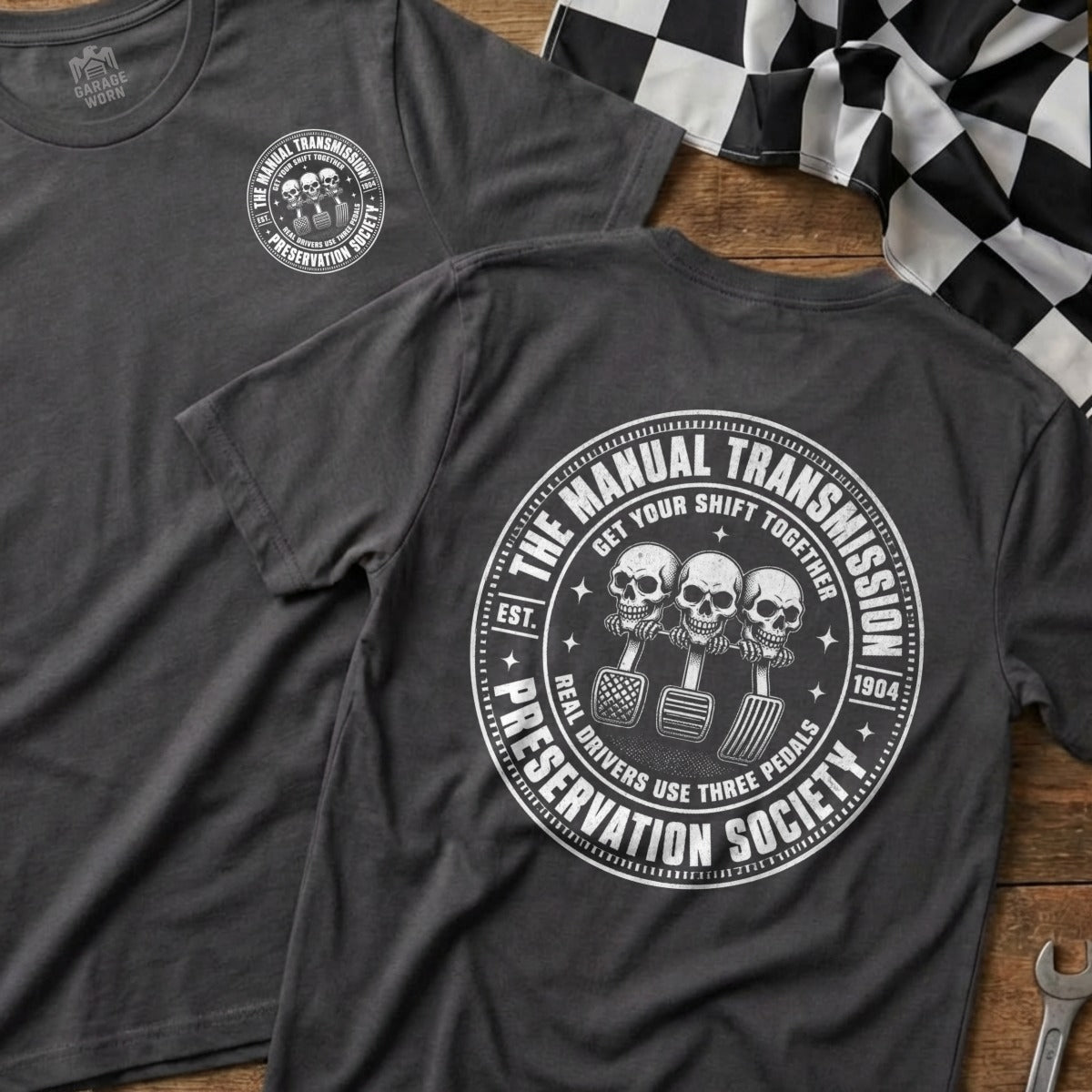 Dark grey t-shirt with "The Manual Transmission Preservation Society" logo.