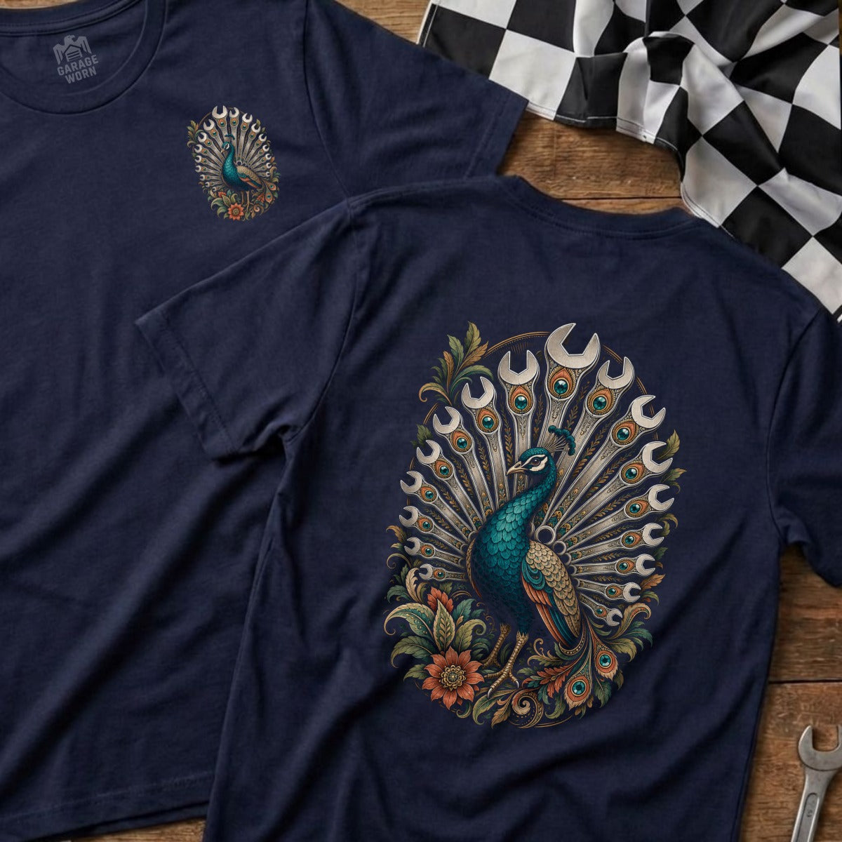 Navy t-shirt with a peacock graphic made of wrenches and accented with flowers.