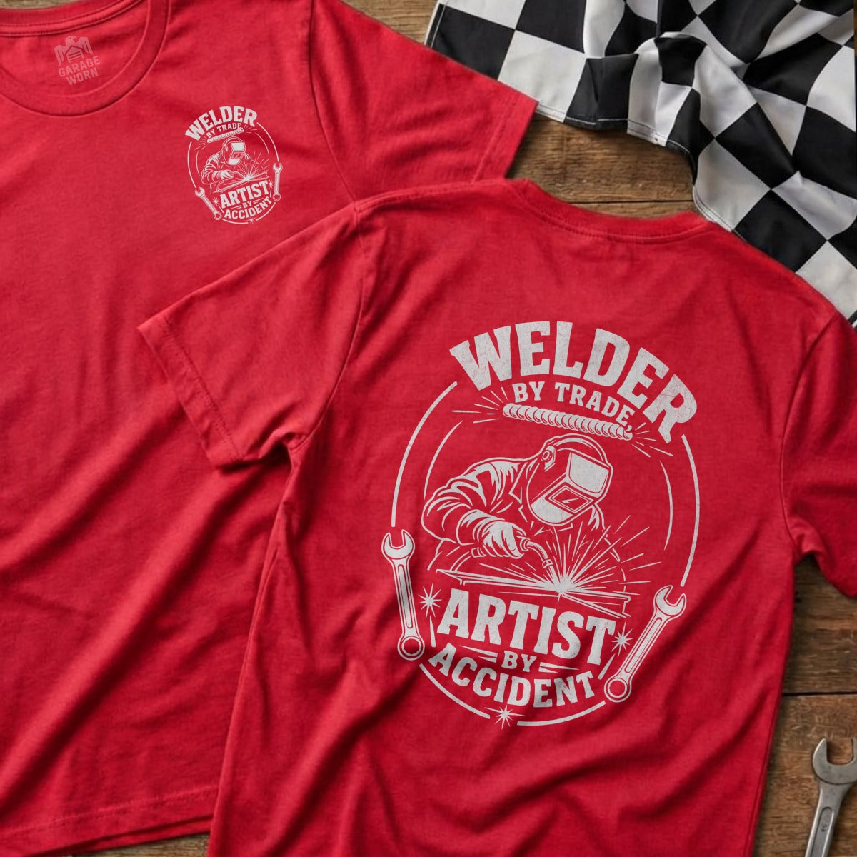Red t-shirts with "Welder by Trade, Artist by Accident" graphic.
