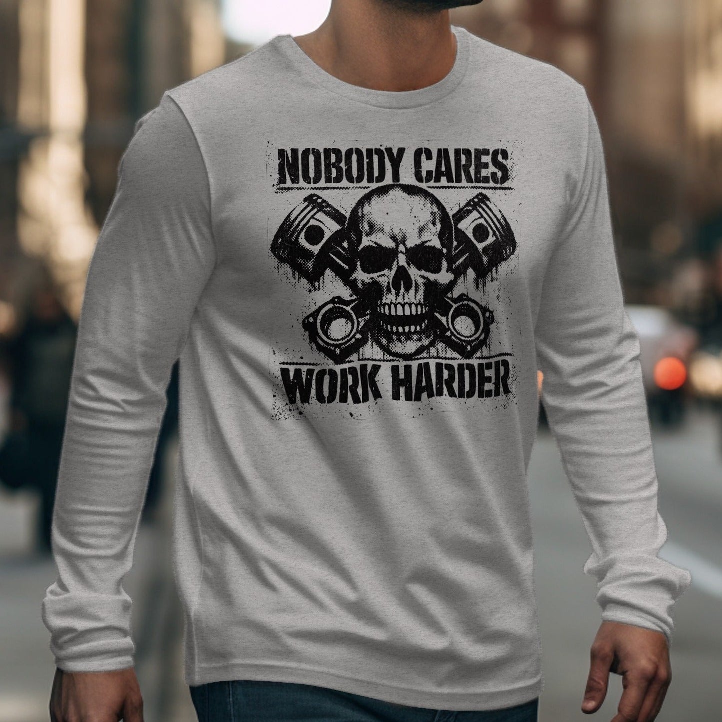 Gray long-sleeve shirt with skull, pistons, and text reading "NOBODY CARES WORK HARDER".