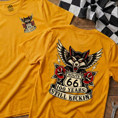 Yellow t-shirt with Route 66 wolf graphic: "100 Years: Still Kickin."