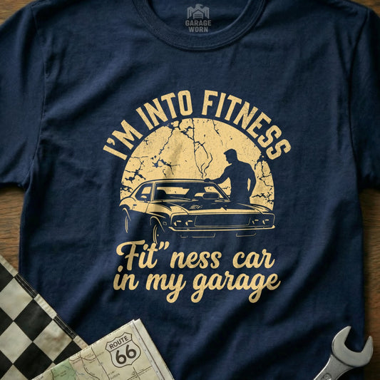 T-shirt with "I'm Into Fitness" and a car in a garage.