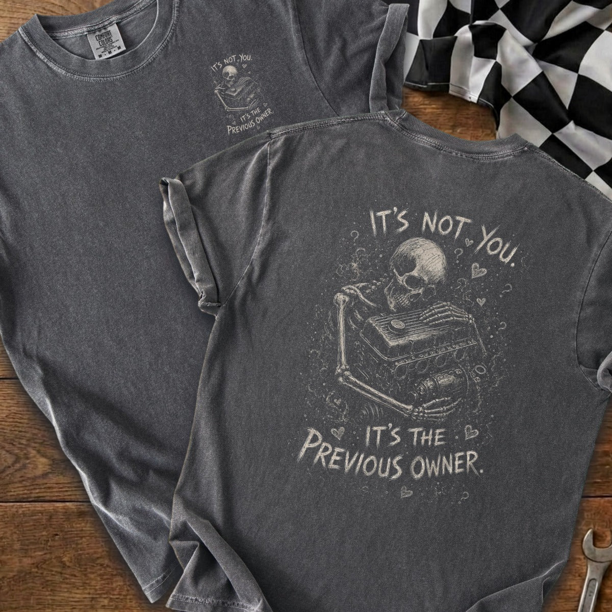 Gray t-shirt featuring a skeleton hugging an engine with text "It's not you. It's the previous owner."