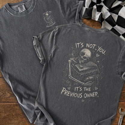 Gray t-shirt featuring a skeleton hugging an engine with text "It's not you. It's the previous owner."
