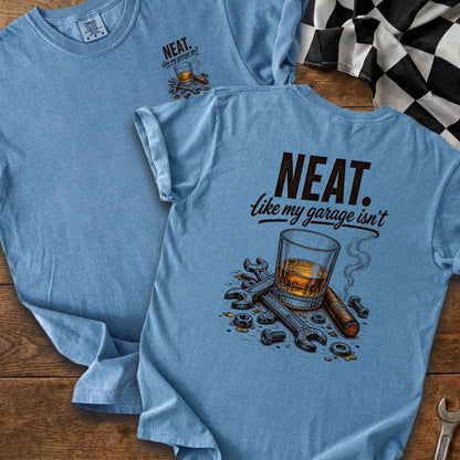 Blue t-shirt with "NEAT. like my garage isn't" text and whiskey, cigar, and tools graphic.