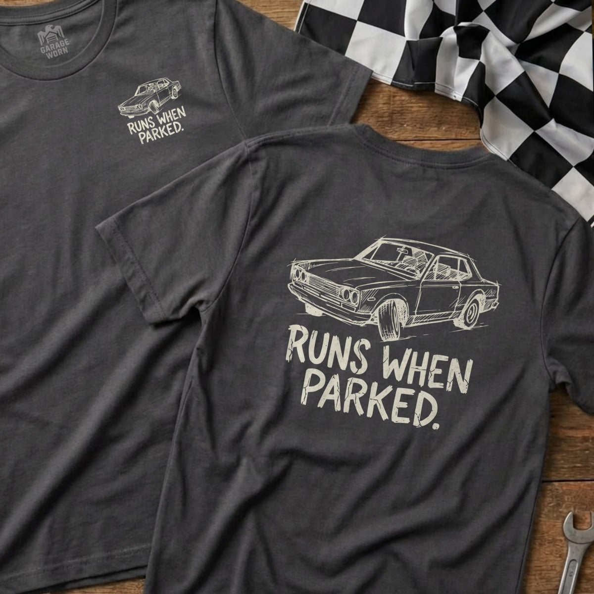 Dark grey t-shirt with a sketch of a car and text "Runs When Parked."
