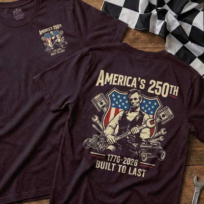 Burgundy t-shirt with "America's 250th" graphic featuring Abraham Lincoln and pistons.