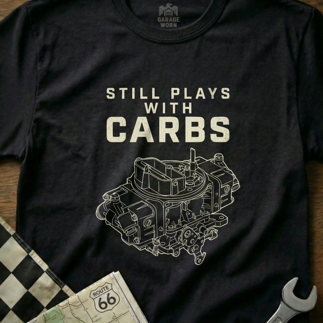 Black t-shirt with "STILL PLAYS WITH CARBS" and a detailed carburetor illustration.
