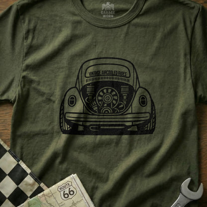 T-shirt with black graphic of vintage air-cooled Volkswagen Beetle rear view.