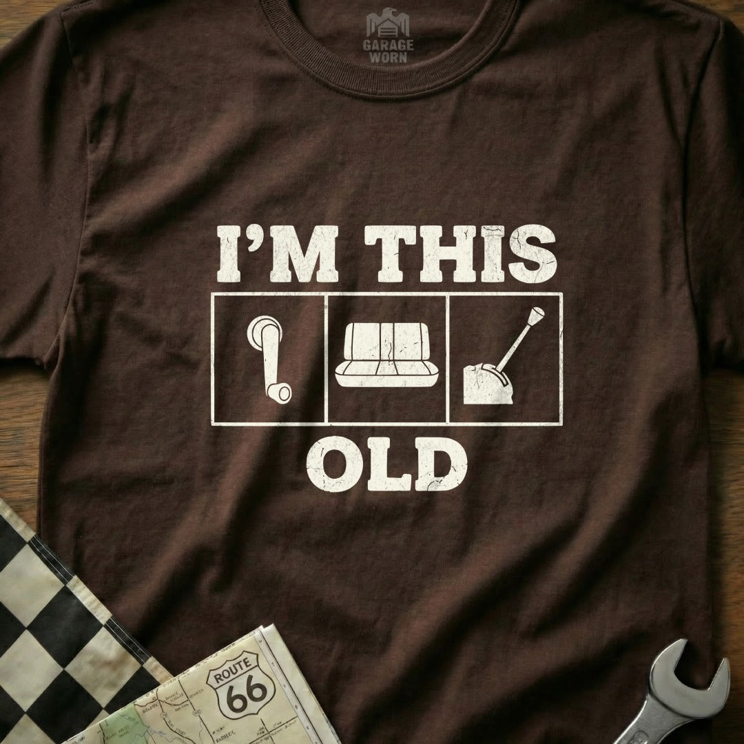 Brown t-shirt with "I'M THIS OLD" text and car parts graphics.