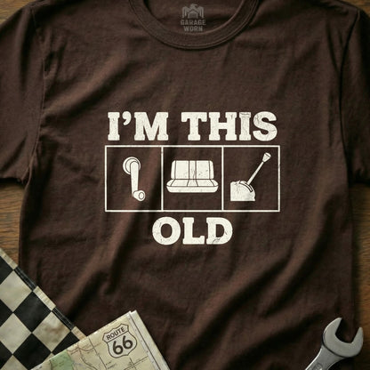 Brown t-shirt with "I'M THIS OLD" text and car parts graphics.