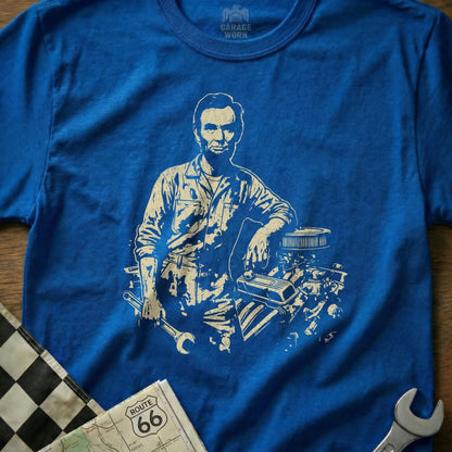 Abraham Lincoln leaning on an engine with tools and checkered flag.