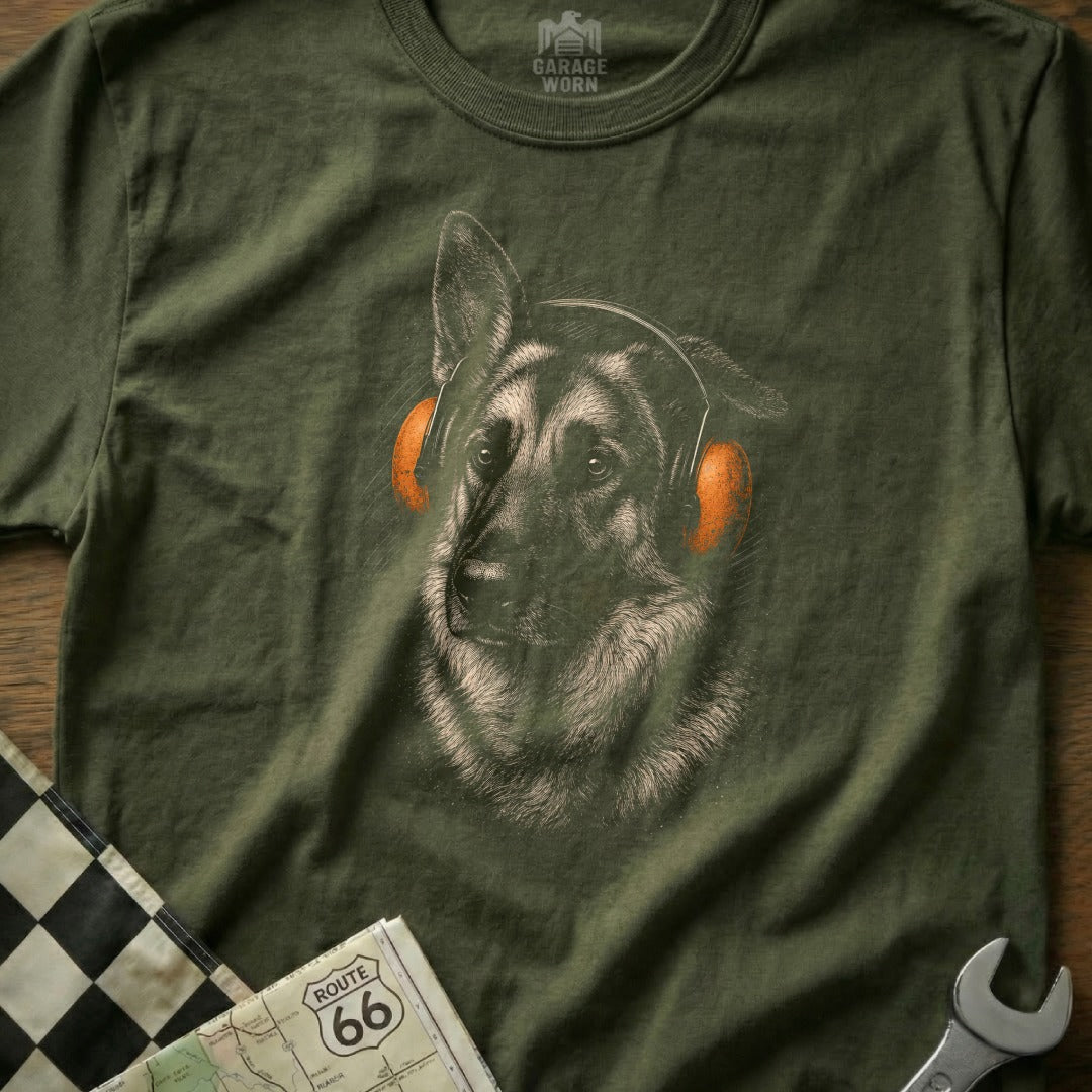 German Shepherd wearing orange headphones on green shirt with Route 66 map.