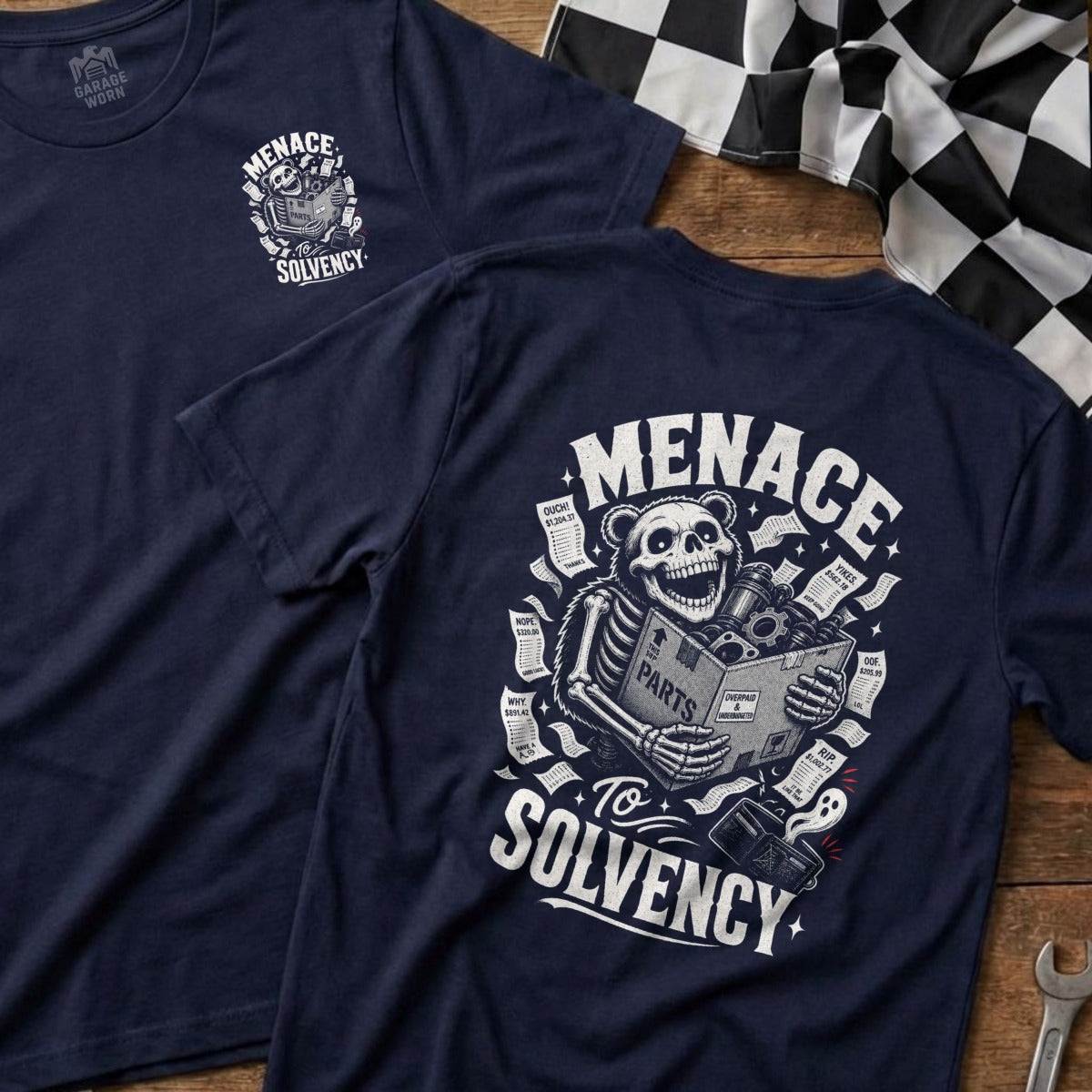 Navy t-shirt graphic: skeleton bear holding parts box, text "Menace To Solvency".