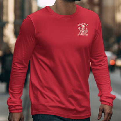 Red long-sleeve shirt with "Hang in there it gets worse" skeleton graphic.