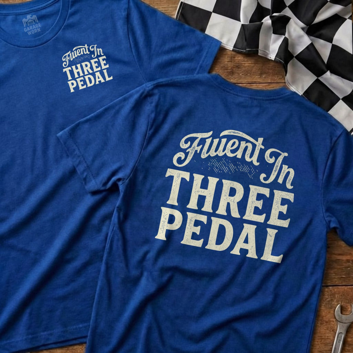 Two blue t-shirts with "Fluent In Three Pedal" text.