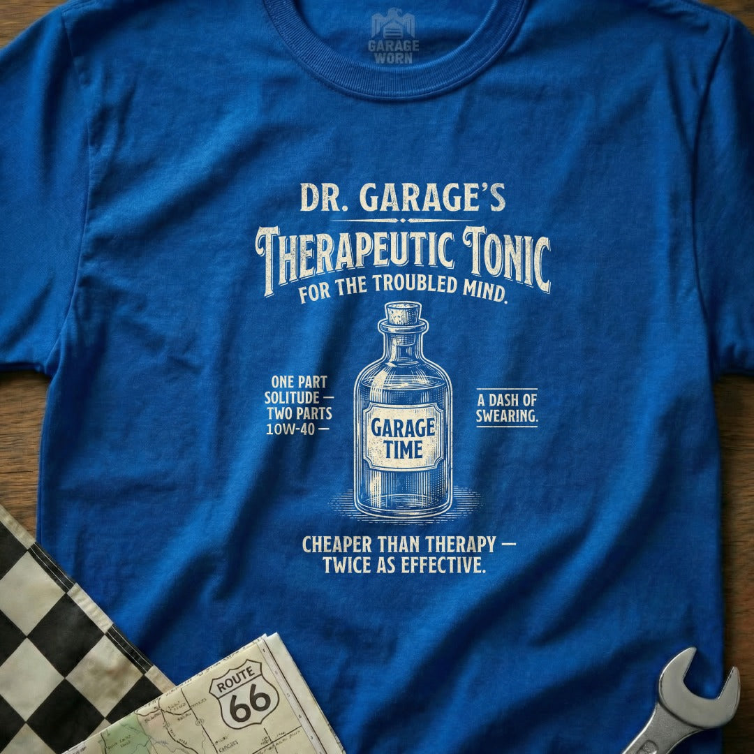 Blue t-shirt with "Dr. Garage's Therapeutic Tonic" bottle graphic and humorous text.