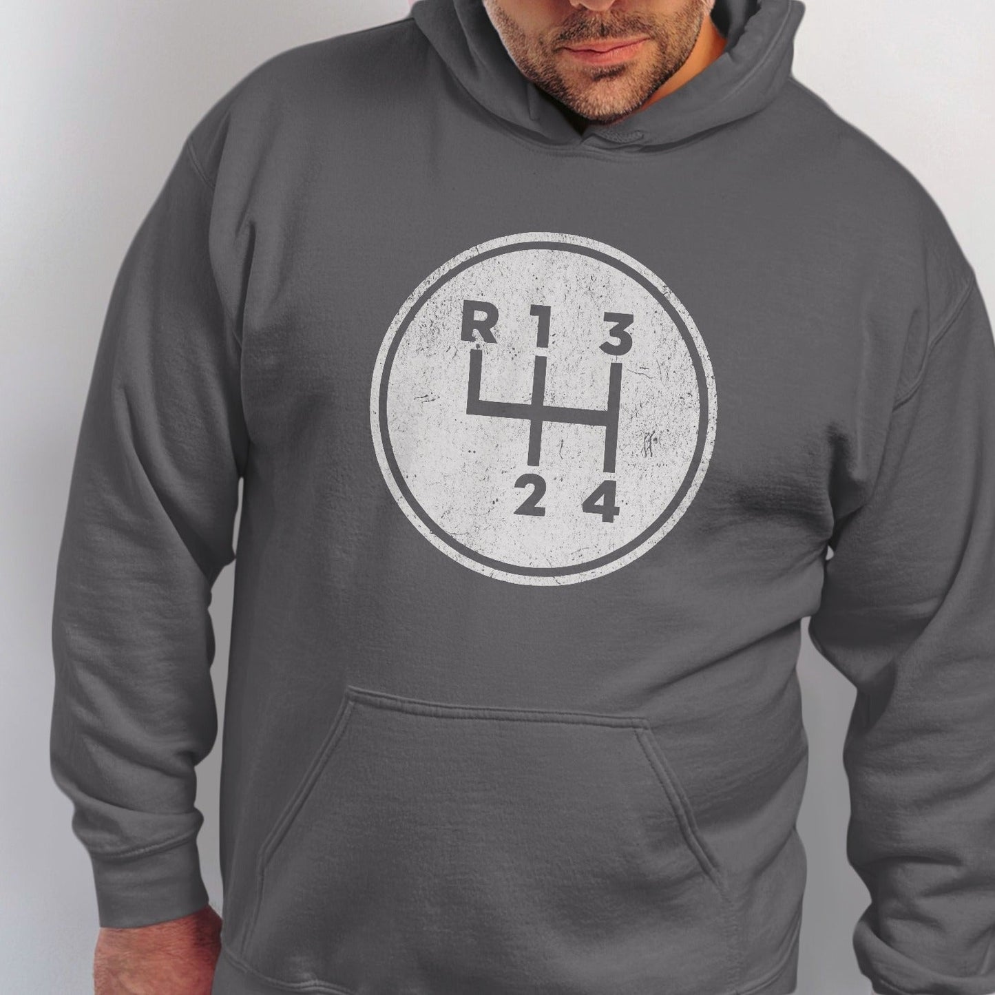 Dark gray hoodie with a vintage-style manual transmission gear shifter graphic.