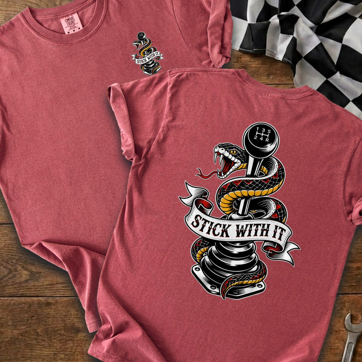 T-shirt with snake coiled around a manual transmission shift knob, reading "STICK WITH IT".