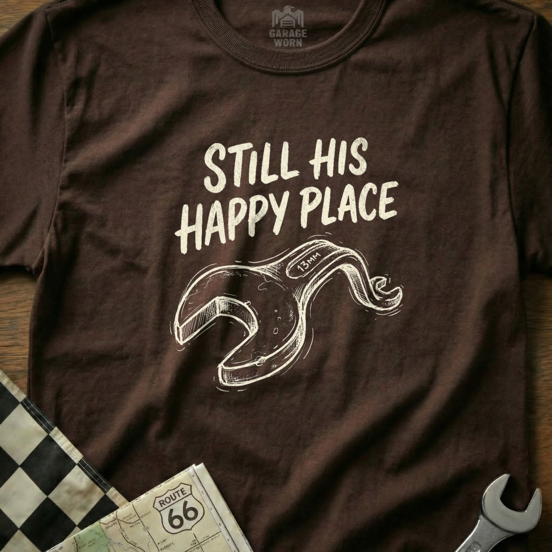Brown t-shirt with white text "Still His Happy Place" and a sketched wrench.