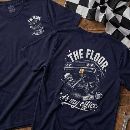Navy t-shirt with "The Floor Is My Office" graphic featuring a skeleton working on a car.