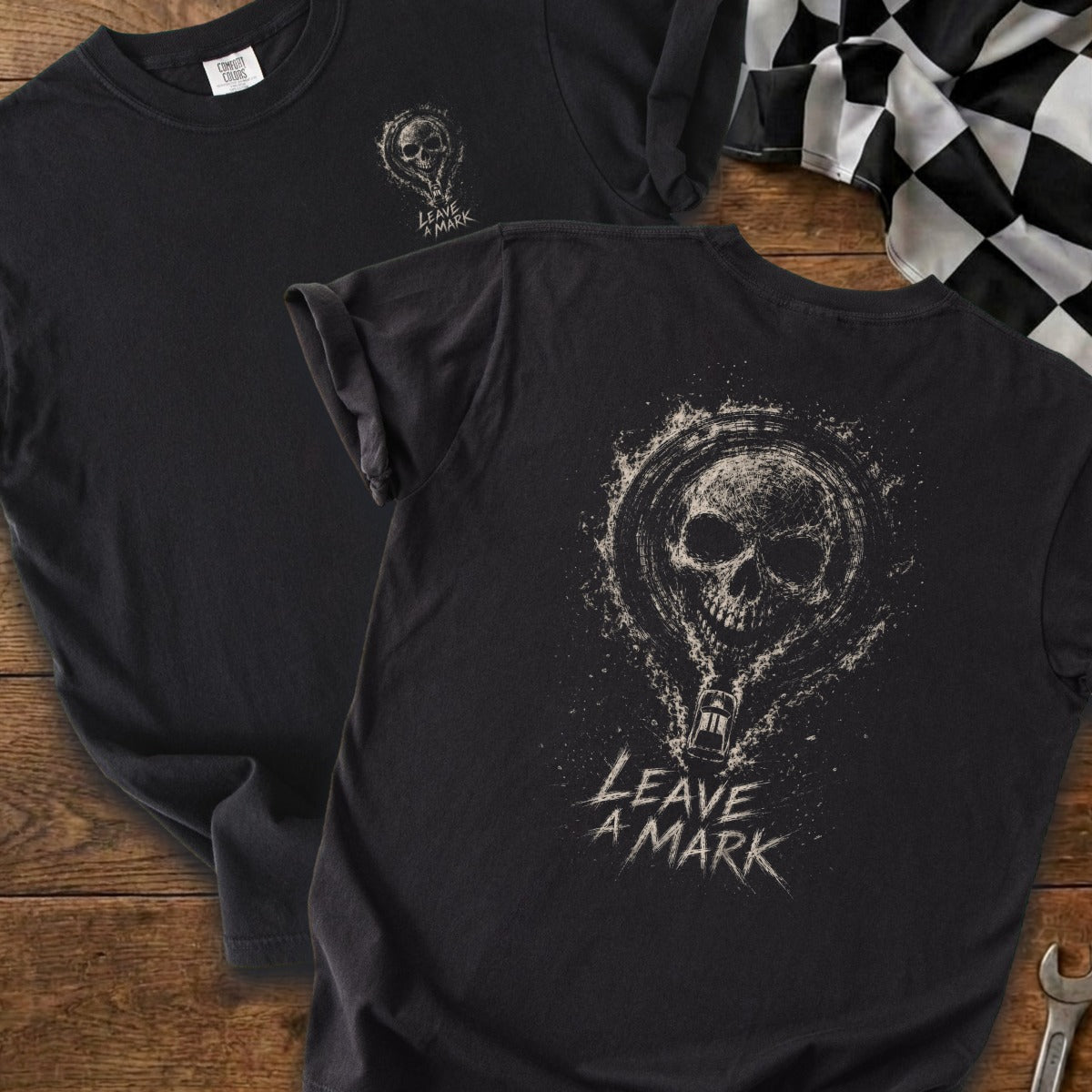 Black t-shirt with distressed skull and hot air balloon graphic, text "LEAVE A MARK."