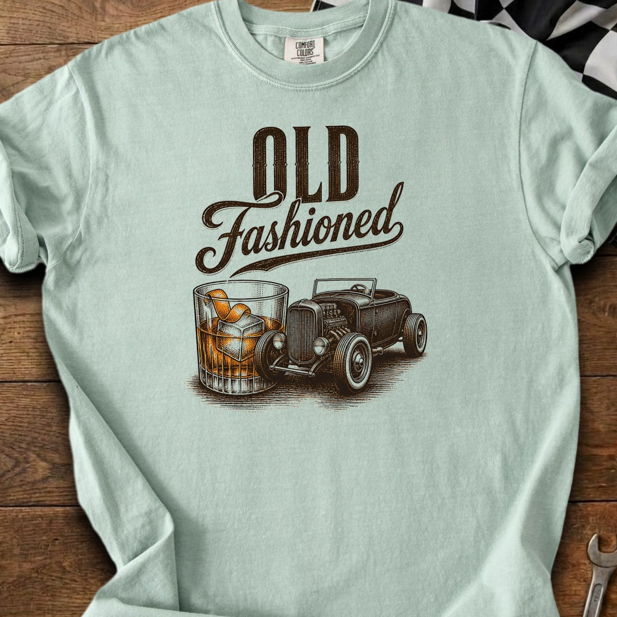 "Old Fashioned" text with a whiskey glass and hot rod on a light blue t-shirt.