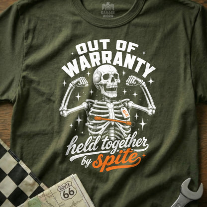 Green t-shirt with a skeleton graphic: "Out of Warranty, Held Together by Spite".
