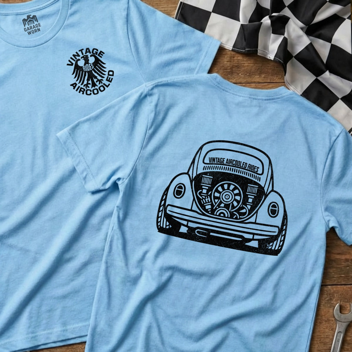 Light blue t-shirt with black graphic of a vintage Volkswagen Beetle rear and "VINTAGE AIRCOOLED" text.