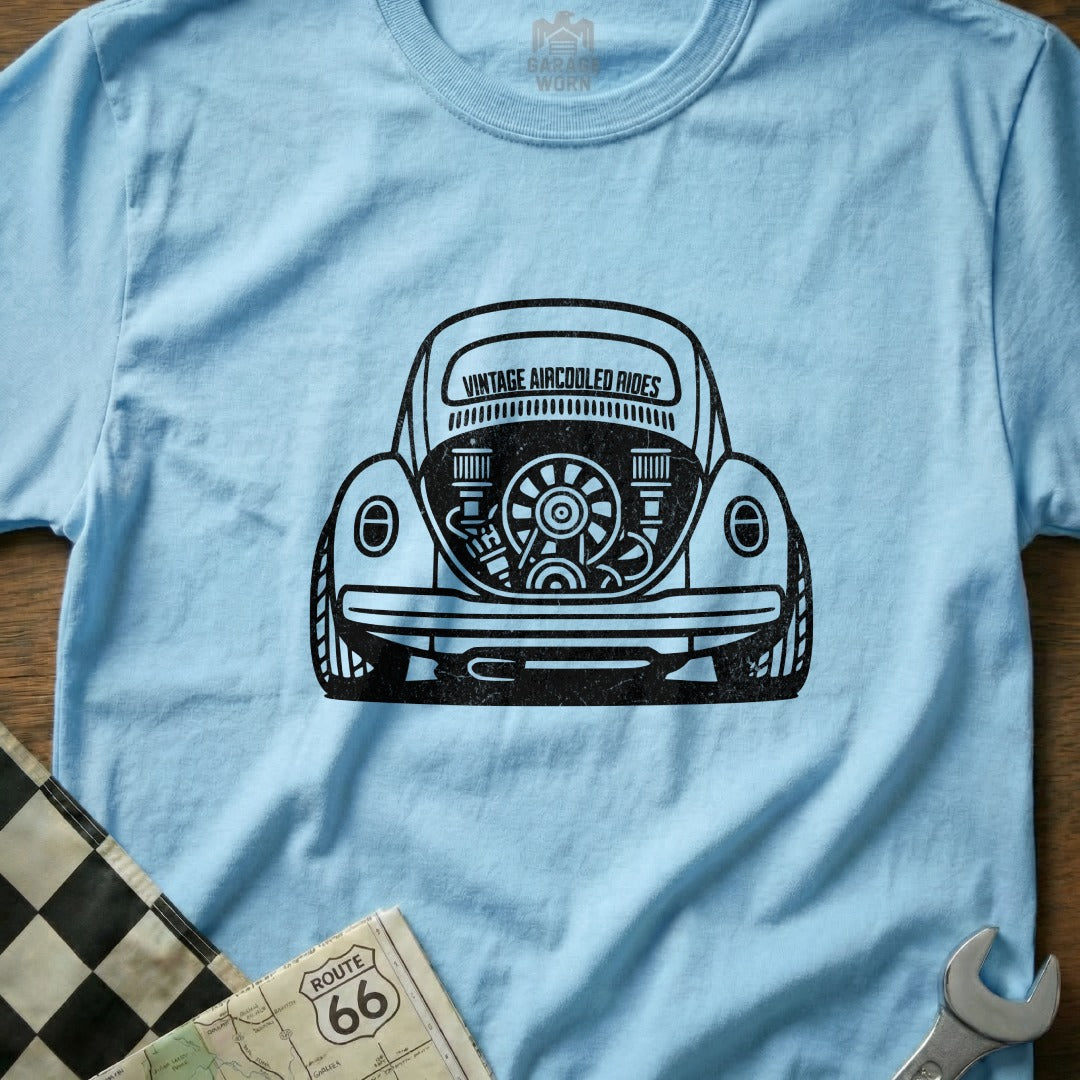 Light blue t-shirt with a black graphic of a vintage Volkswagen Beetle's rear engine.