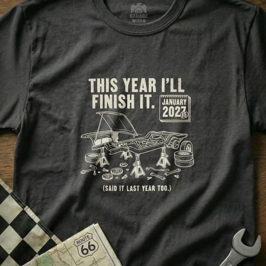 T-shirt with car chassis on jacks and text "This year I'll finish it."