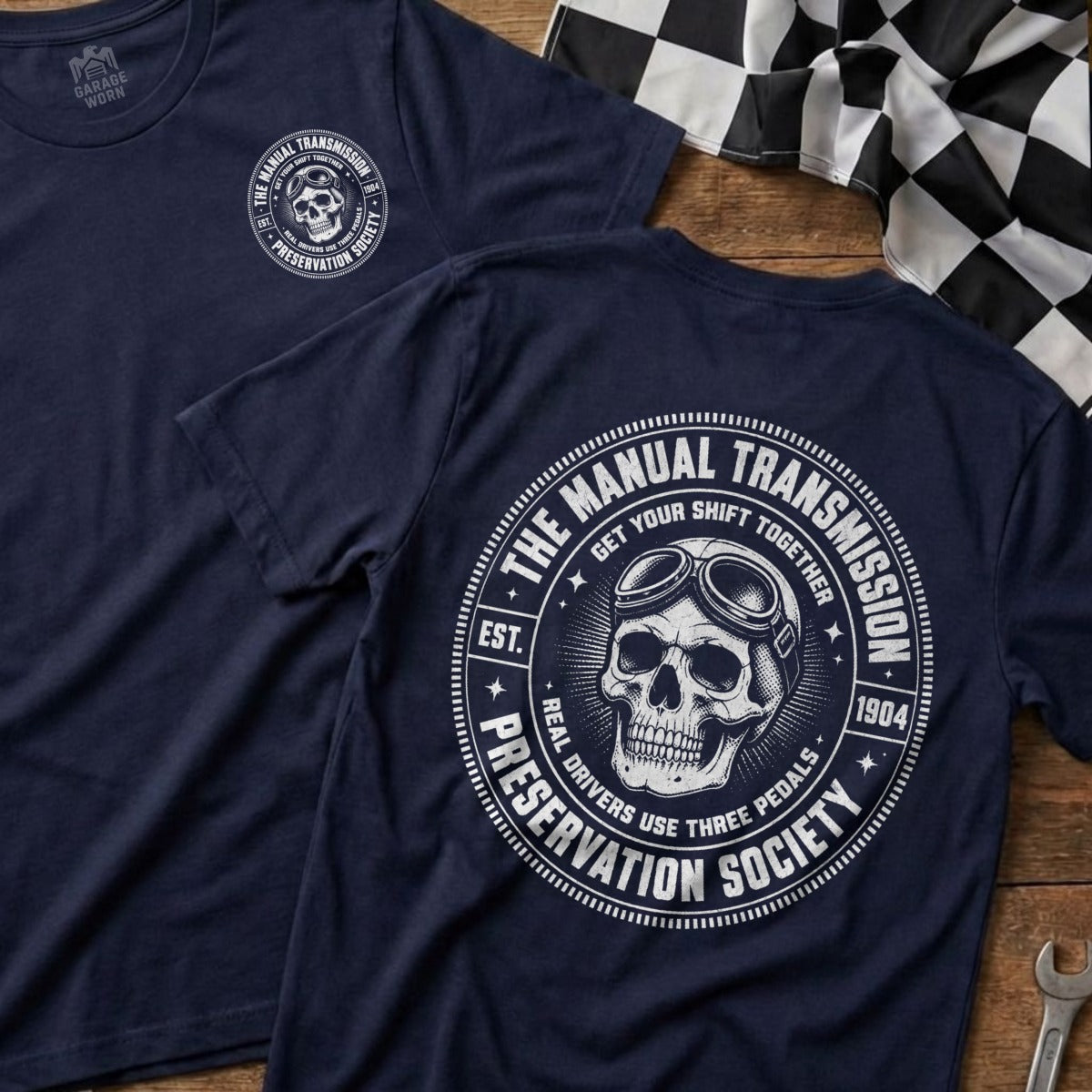 Dark blue t-shirt with white graphic of skull wearing goggles and text "Manual Transmission Preservation Society".