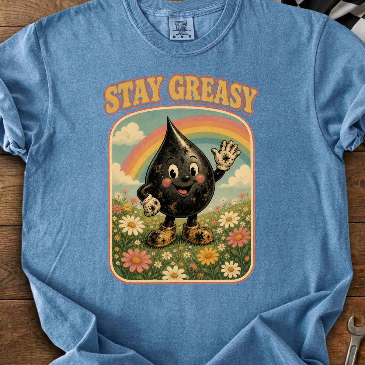 Blue t-shirt with cartoon oil drop character and "STAY GREASY" text.