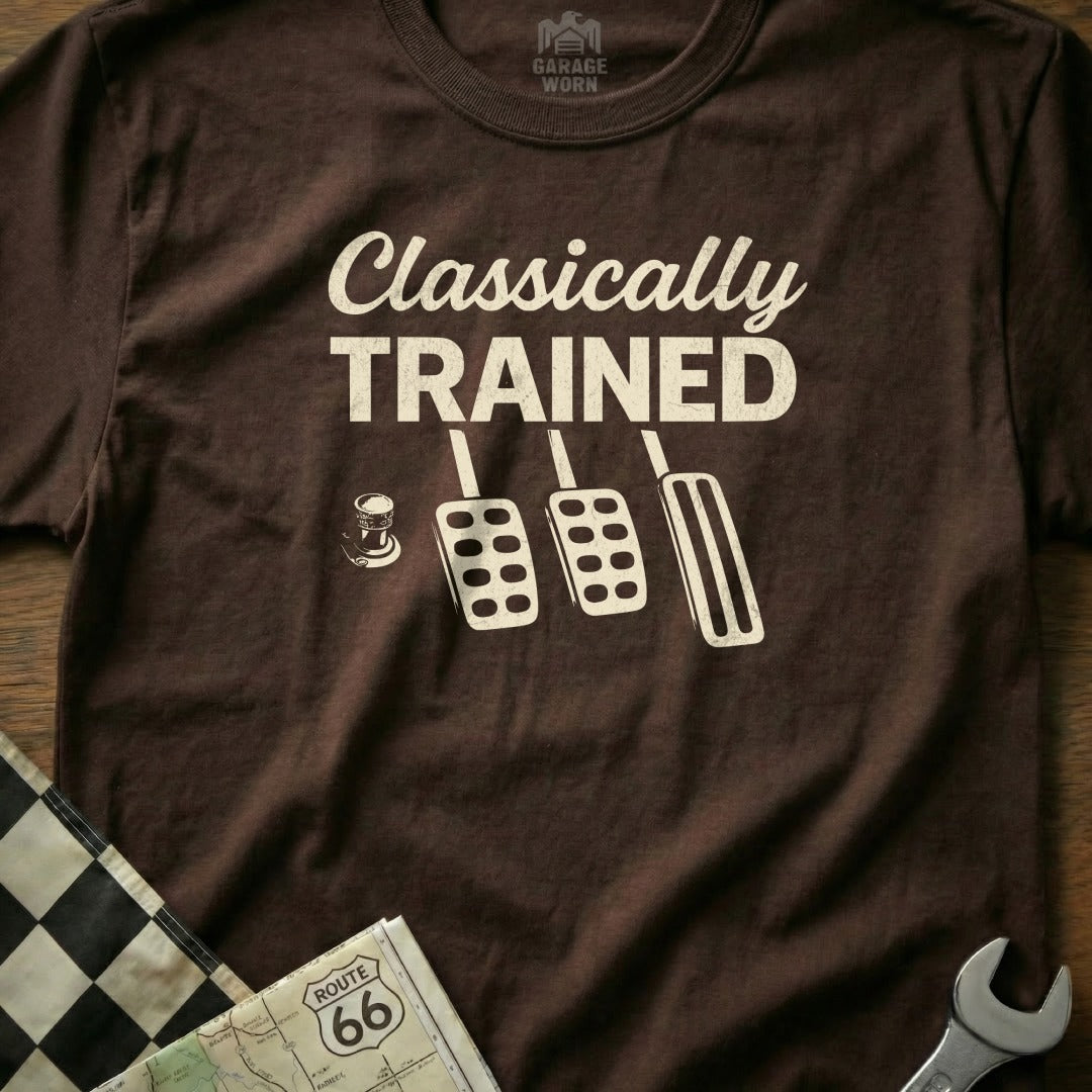 Brown t-shirt with "Classically Trained" text and car pedals graphic.