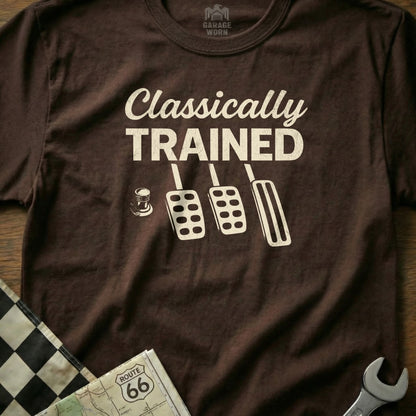 Brown t-shirt with "Classically Trained" text and car pedals graphic.