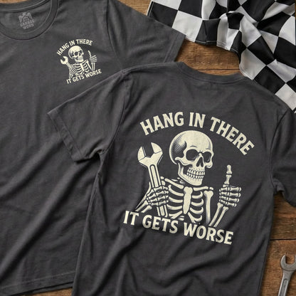 Dark grey t-shirt with a skeleton holding a wrench and text "Hang in there, it gets worse."