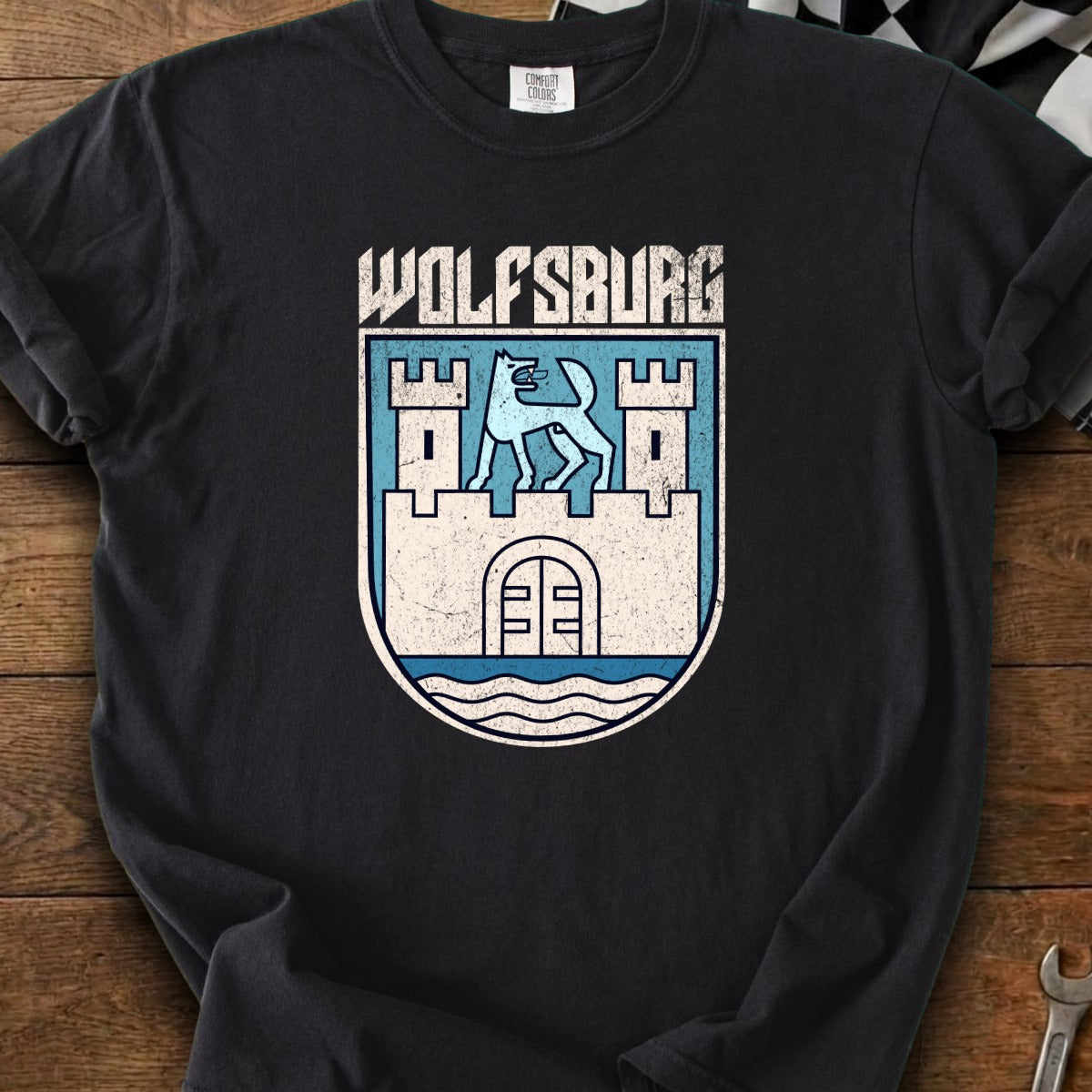 Black t-shirt featuring a distressed Wolfsburg crest with a stylized wolf atop a castle.