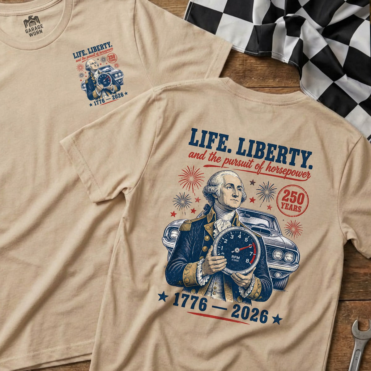 T-shirt graphic showing George Washington holding a tachometer in front of a classic car. Text reads "LIFE, LIBERTY, and the pursuit of horsepower 1776-2026".