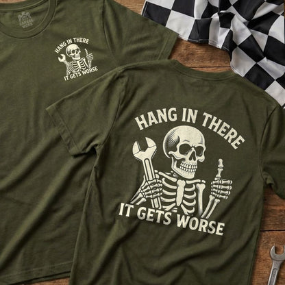 Green t-shirt with skeleton holding wrench, "Hang In There It Gets Worse" text.