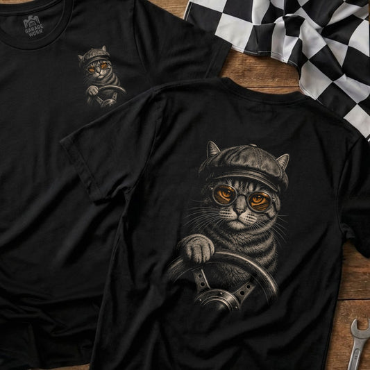 Black t-shirt with graphic of tabby cat wearing cap and glasses driving wheel.
