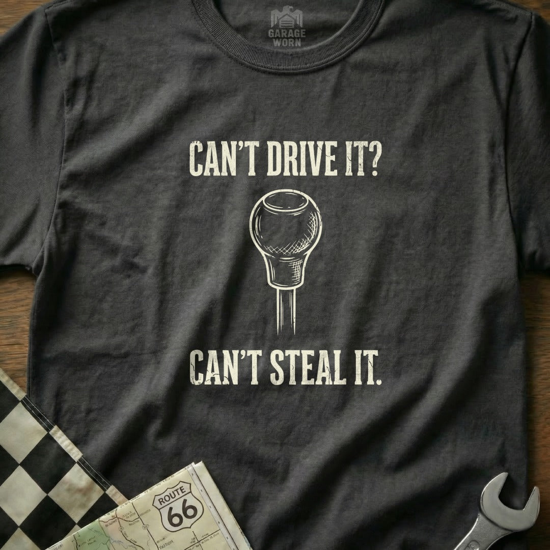 Dark t-shirt with "Can't Drive It? Can't Steal It." and a gear shift knob.